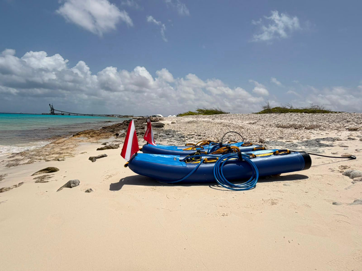 SNUBA gear on a Bonaire beach with the salt pier in the distance
