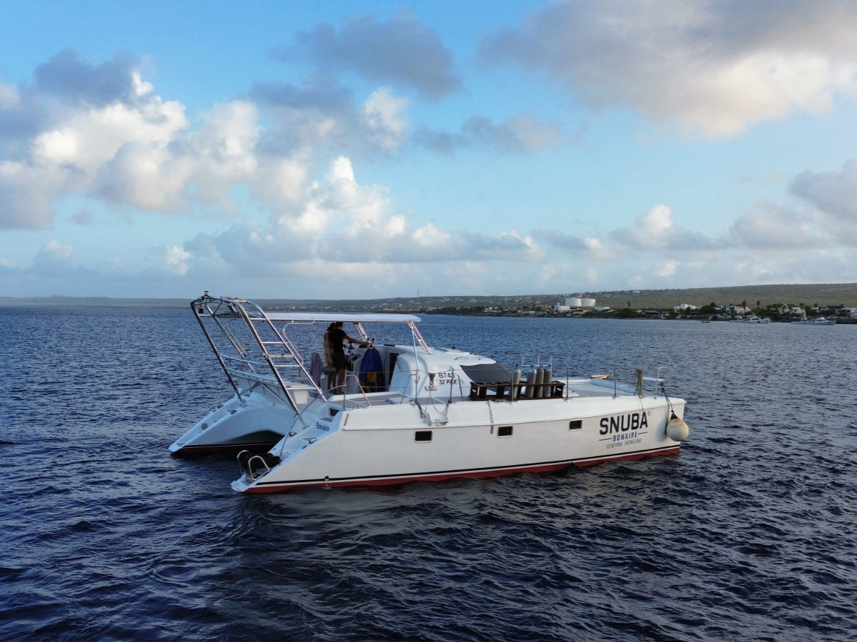 The Mushi Mushi, SNUBA Bonaire's 40-foot motorized catamaran, on the water near Kralendijk
